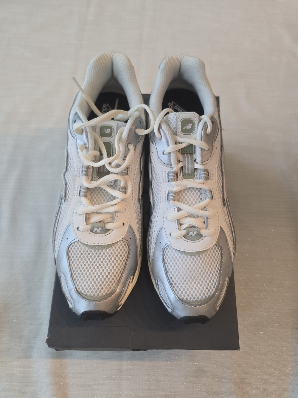 New Balance 204L sneakers in a clean White/Light Gray colorway.